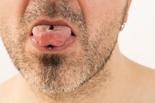 close-up of a mature man showing off his tongue ring