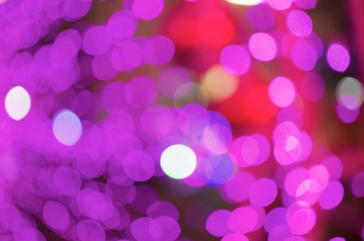 Defocused of glitter or purple and pink bokeh circle at night as background.