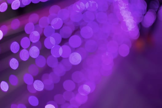 Defocused of glitter or purple bokeh circle at night as line background.