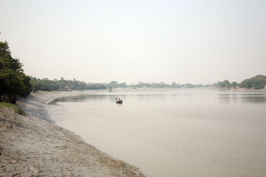 Wooden boat crosses the Ganges River January 19, 2009 in Gosaba, West Bengal, India