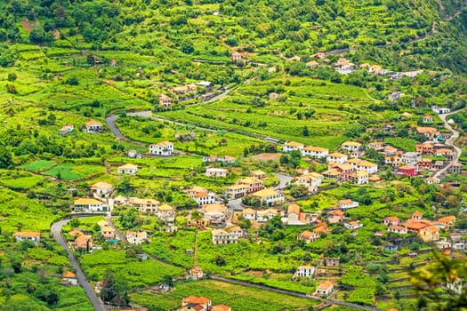 Village / town Arco de Sao Jorge, Madeira - typical madeiran landscape, residential houses with orange roofs sourrounded by green terraced nature