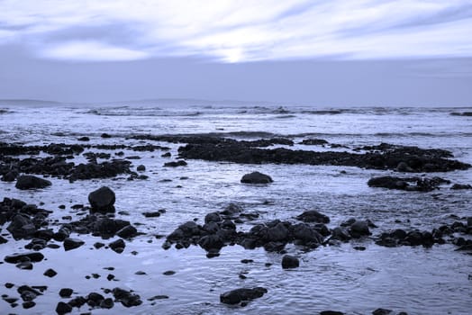 reflections at rocky beach near ballybunion on the wild atlantic way ireland with a beautiful blue tone