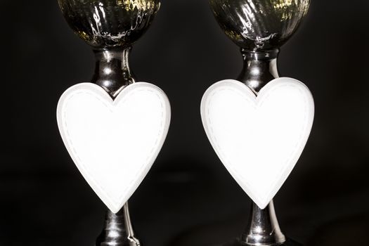 Champagne and valentines day decoration on black glitter background, love