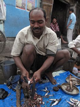 Man selling fish at a street market on February 01, 2009 in the Chowringhee area of Kolkata, West Bengal, India