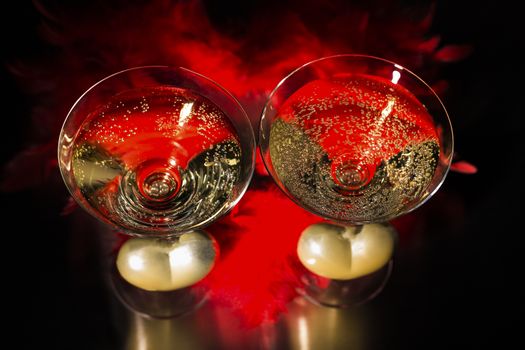 Champagne and valentines day decoration on black glitter background, love