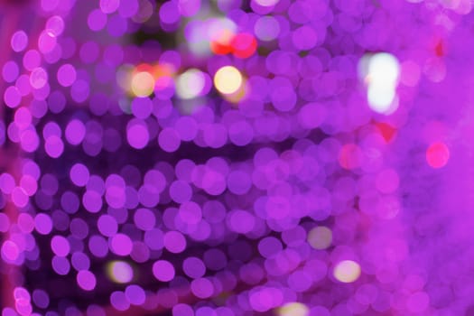 Defocused of glitter or purple bokeh circle at night as background.