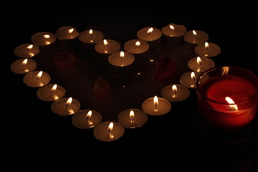 Heart of candles, a sign of love. romantic evening