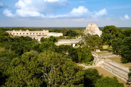 Landscape view of Uxmal archeological site with pyramids and ruins, Mexico