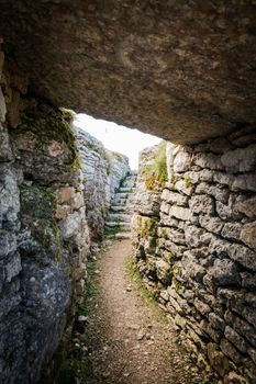 Trench dug in the rock dating back to World War I located on the Italian alps.