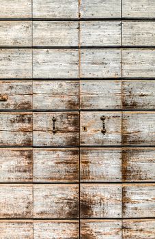 Texture formed by a discolored old wooden portal.