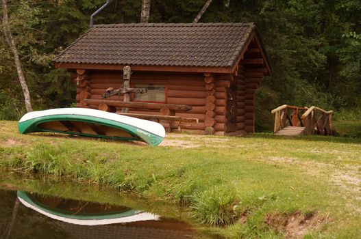 Boat and lake with wood house