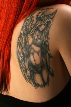 Sexy red hair girl with beautiful tatoo