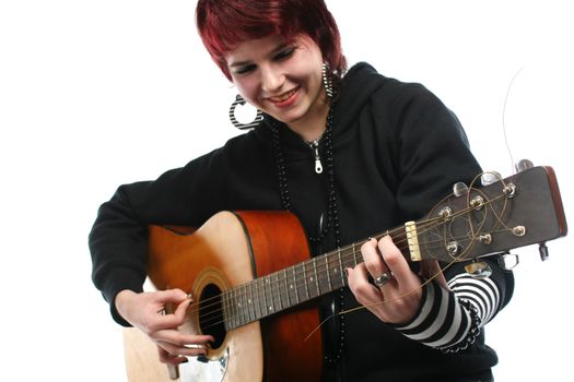 Teenage girl learning to play guitar