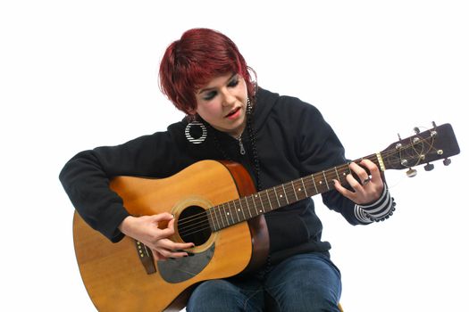 Teenage girl learning to play guitar