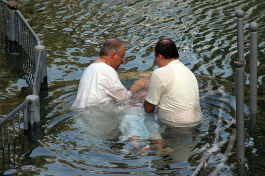 Baptismal site at Jordan river shore. Baptism of pilgrims  in Yardenit, Israel on September 30, 2006.