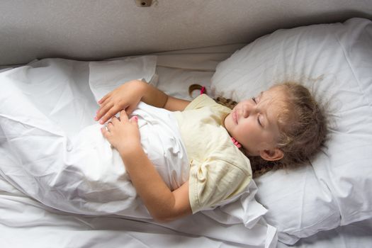 Four-year girl sleeping on a cot in a second-class train carriage