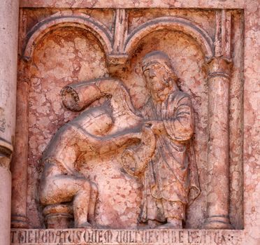 Christ Performing Works of Mercy relief at the baptistry from Benedetto Antelami, Parma, Emilia Romagna, Italy
