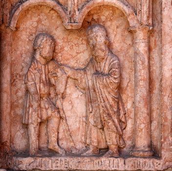 Christ Performing Works of Mercy relief at the baptistry from Benedetto Antelami, Parma, Emilia Romagna, Italy