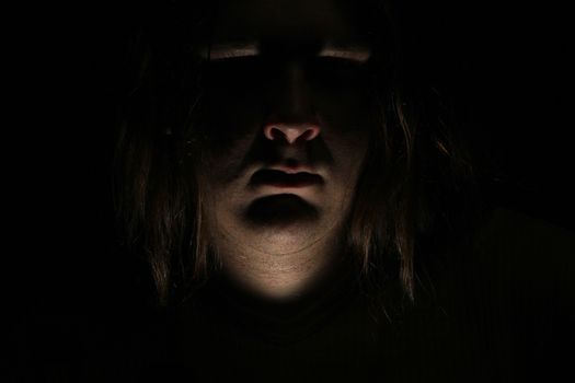 Dark evil face on black background