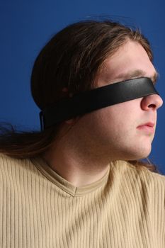 Man with a belt over his eyes