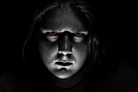 Dark evil face on black background