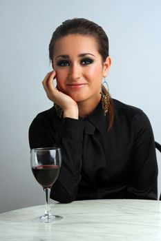 Beautiful business lady in a restaurant celebrating with red wine