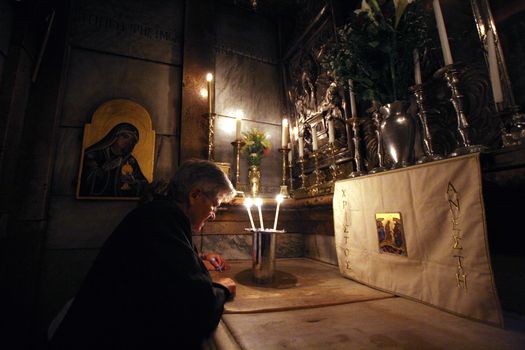 Pilgrims pray at the tomb of Jesus in the Church of the Holy Sepulchre, traditional site of the crucifixion, burial, and resurrection of Jesus, on October 01, 2006.