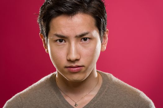 A headshot of a young handsome Japanese man.