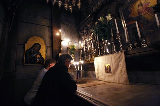 Pilgrims pray at the tomb of Jesus in the Church of the Holy Sepulchre, traditional site of the crucifixion, burial, and resurrection of Jesus, on October 01, 2006.