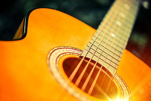 Acoustic Wooden Guitar Closeup Photo. Guitar Playing Concept.
