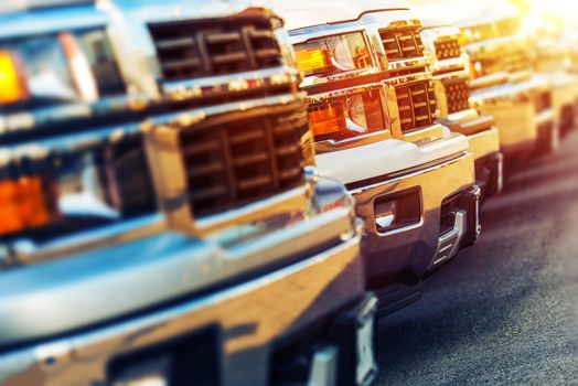 Car Sales Business Photo Concept. Row of Brand New Vehicles For Sale at Dealer Parking Lot. American Car Sale Business.