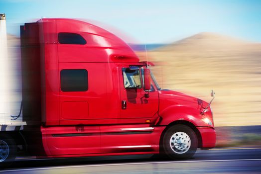 Red Semi Truck on the Road. Semi Truck Tractor Closeup. American Road Transportation.