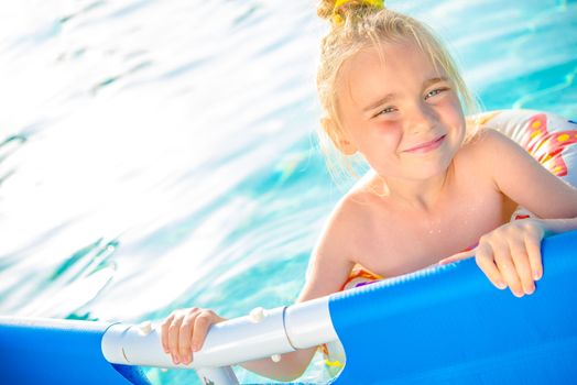 Little Girl Enjoying Backyard Swimming Pool. Summertime Water Fun. 