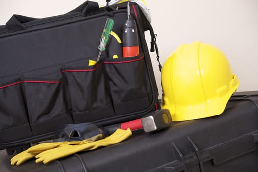 Construction Tools Bag and Safety Equipment Like Yellow Helmet and Gloves.