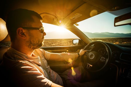 Crossing Southern California Desert by Car. Young Driver on the Journey.