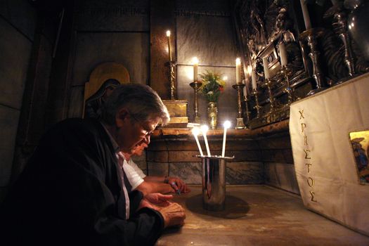 Pilgrims pray at the tomb of Jesus in the Church of the Holy Sepulchre, traditional site of the crucifixion, burial, and resurrection of Jesus, on October 01, 2006.
