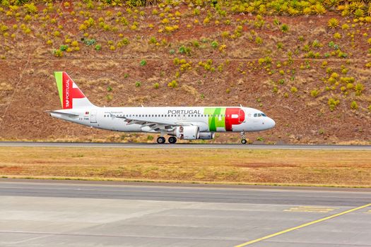 Funchal, Madeira, Portugal - May 30, 2013: At the airport of Madeira (Aeroporto Madeira) - an airplane Airbus A320 from TAP Portugal Airline on runway.