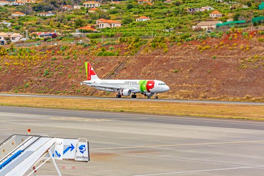 Funchal, Madeira, Portugal - May 30, 2013: At the airport of Madeira (Aeroporto Madeira) - an airplane Airbus A320 from TAP Portugal Airline has landed.