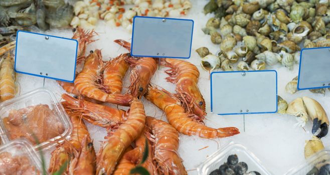 Large king prawns and other seafood popular food for easter and christmas for sale at fish markets