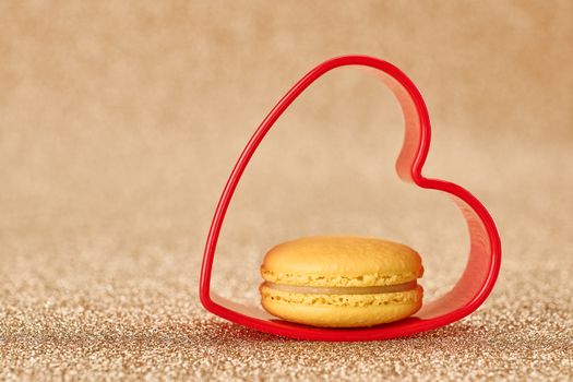 Valentines Day. Love. Red heart, Macaron french sweet delicious dessert yellow. Vintage retro romantic style. Unusual creative art greeting card, gold background, copyspace