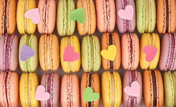 Macarons sweet traditional french colorful. A lot of fresh  pastel delicious dessert in box with multicolored hearts. Retro vintage background. Love, Valentines Day