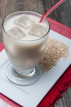 Quinoa drink glass with ice on a plate