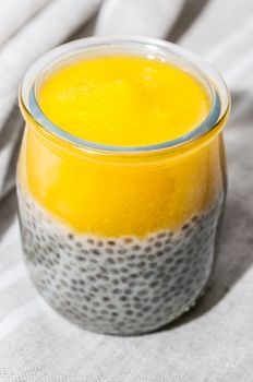 Mango dessert and chia seeds on a tablecloth