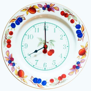 dish wall clock painted with colorful fruit ornament isolated on white background