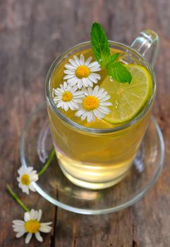 cup of chamomile tea with chamomile flowers