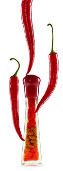 Red hot pepper in pods around the bottle with pickled vegetables on white background