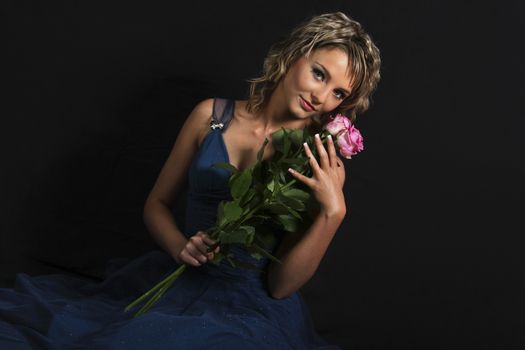 Young Woman Holding Rose Over Black Background