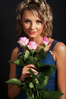 Beautiful girl smelling roses