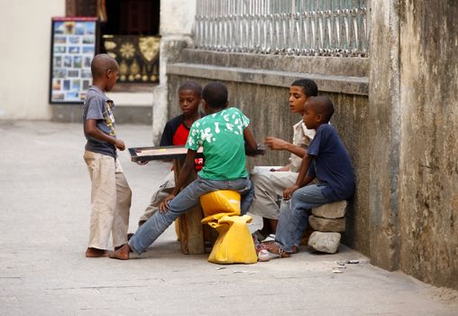 Zanzibar, Tanzania - January 10, 2016: East Africa, unknown dark skinned children, about 8 years old, playing outdoor, in Stone Town, Zanzibar.