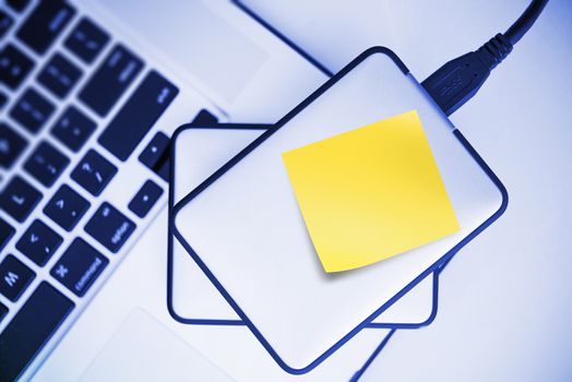 External Hard Drives Backup For Laptop. Small Portable Hard Drive with Yellow Sticky Paper Note. Mobile Workstation.